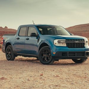 A blue Ford Maverick pickup truck in a serene desert landscape near Page, Arizona.